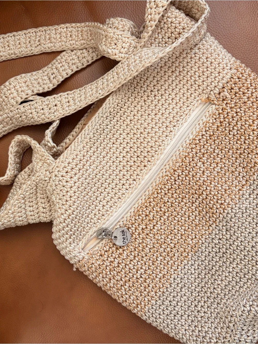 The Sak Silver Round Logo Tag on Cream Braided Accent